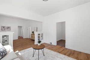 Living room featuring light wood-style floors and baseboards