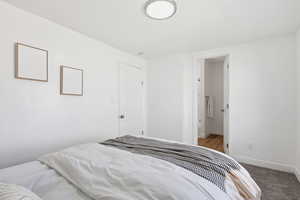 Bedroom featuring ensuite bath and light colored carpet