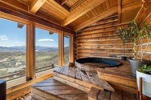Relaxing sauna featuring log walls and wood ceiling