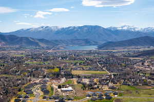 View of mountain background featuring nearby suburban area and a large body of water