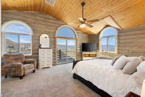 Carpeted bedroom with rustic walls, a mountain view, access to exterior, wood ceiling, and ceiling fan