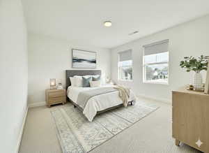 Bedroom featuring light carpet