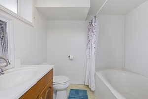 Bathroom with vanity and shower / bathtub combination with curtain