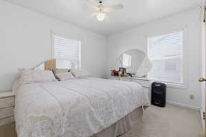 Bedroom featuring light carpet and a ceiling fan