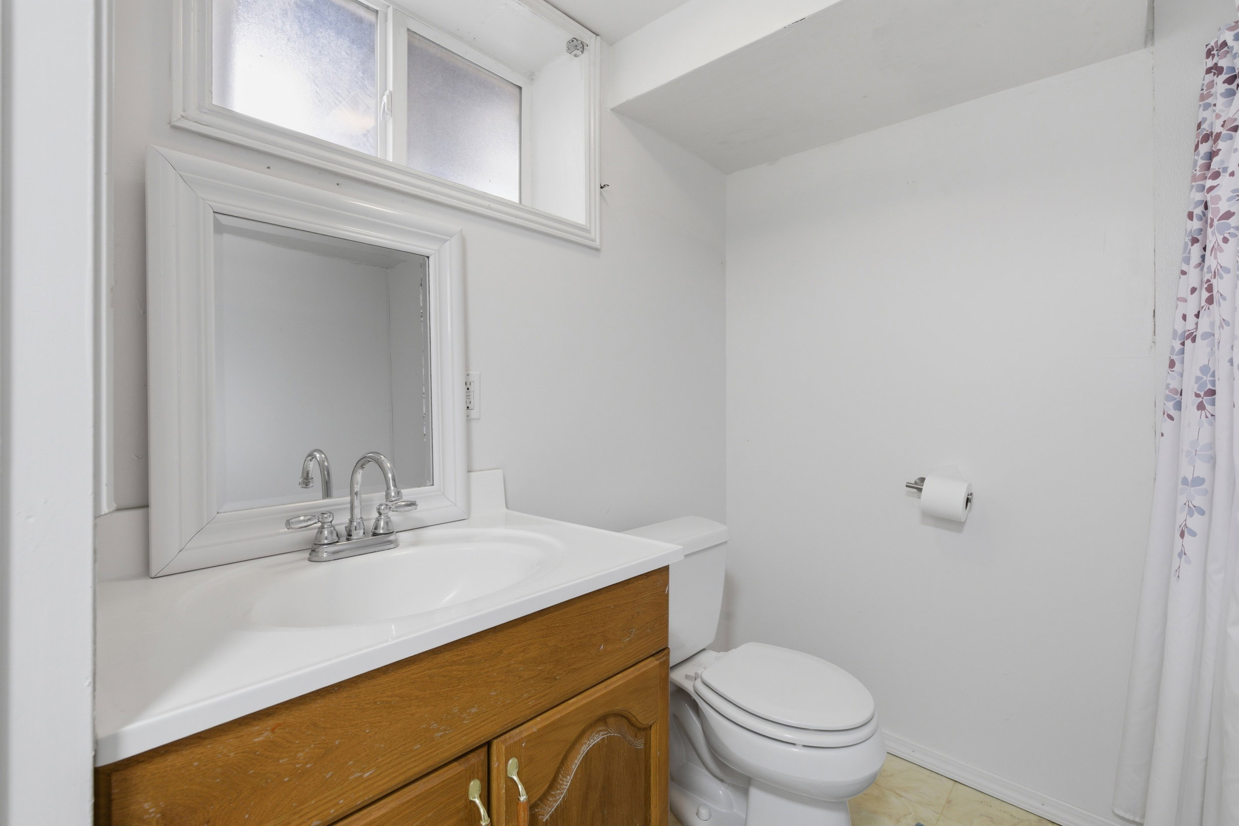 Bathroom with vanity and a shower with shower curtain