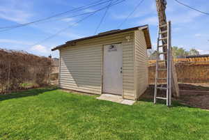 View of shed featuring a fenced backyard
