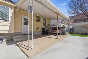 View of patio featuring grilling area and entry steps