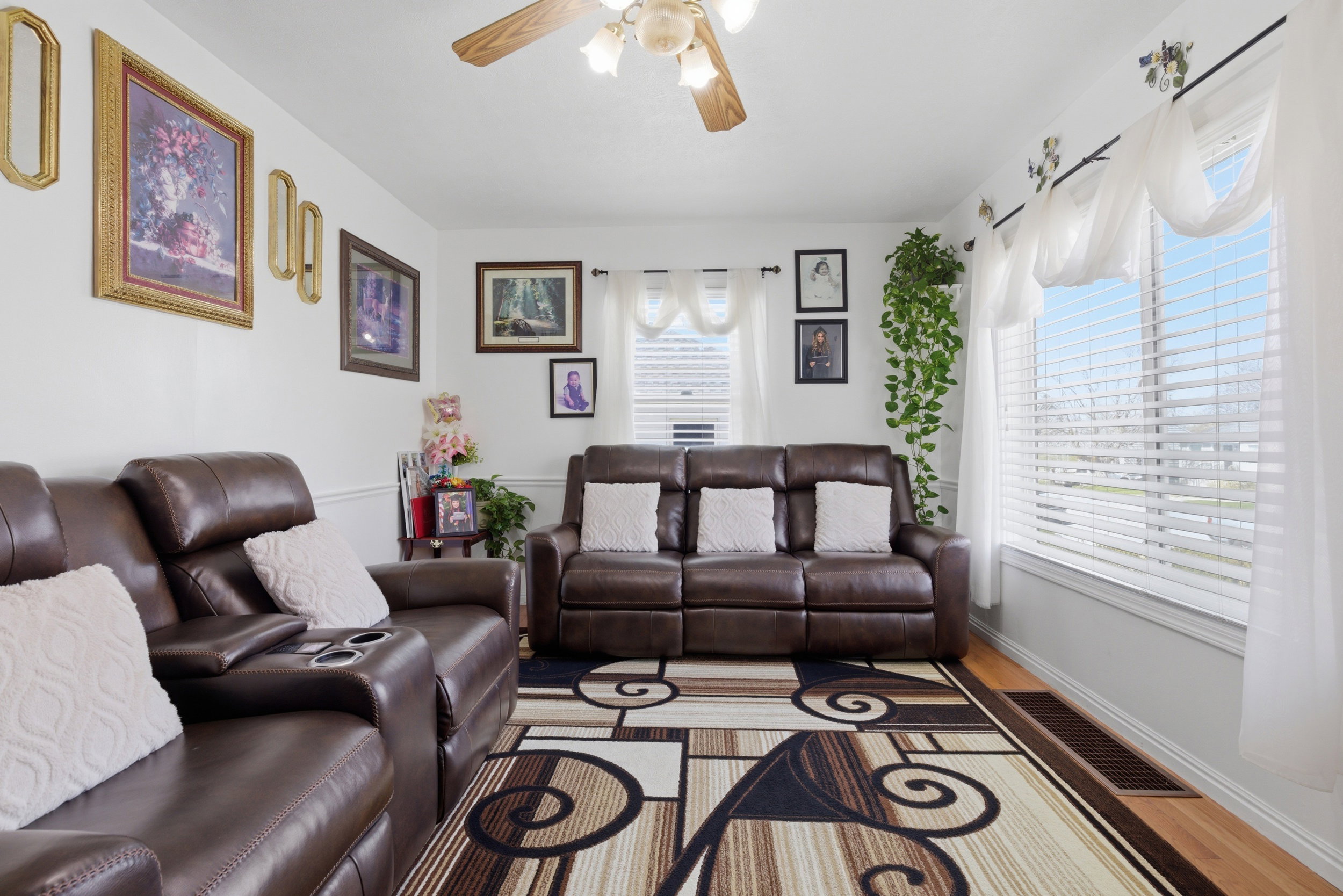 Living area with a ceiling fan and light wood finished floors