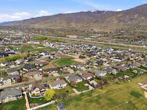 Aerial view of property's location featuring nearby suburban area and mountains