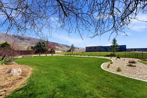 Fenced yard with a mountain view and a rural view