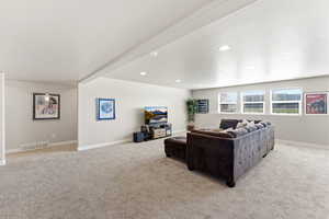 Living room featuring light colored carpet and recessed lighting