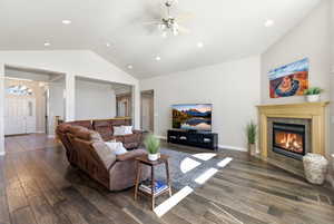 Living area with dark wood-style floors, recessed lighting, ceiling fan, and a tiled fireplace