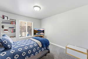 Carpeted bedroom featuring baseboards