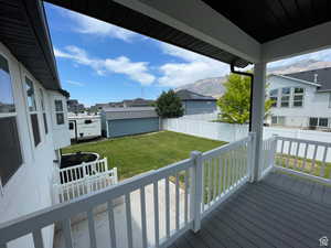 Wooden deck featuring a shed and a fenced backyard