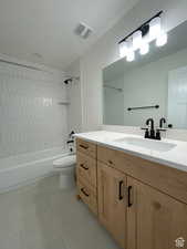 Full bath with vanity, bathtub / shower combination, and light tile patterned floors