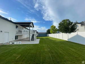 Fenced yard featuring a patio and stairway