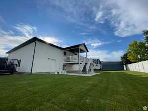 Rear view of house featuring a patio area and stucco siding