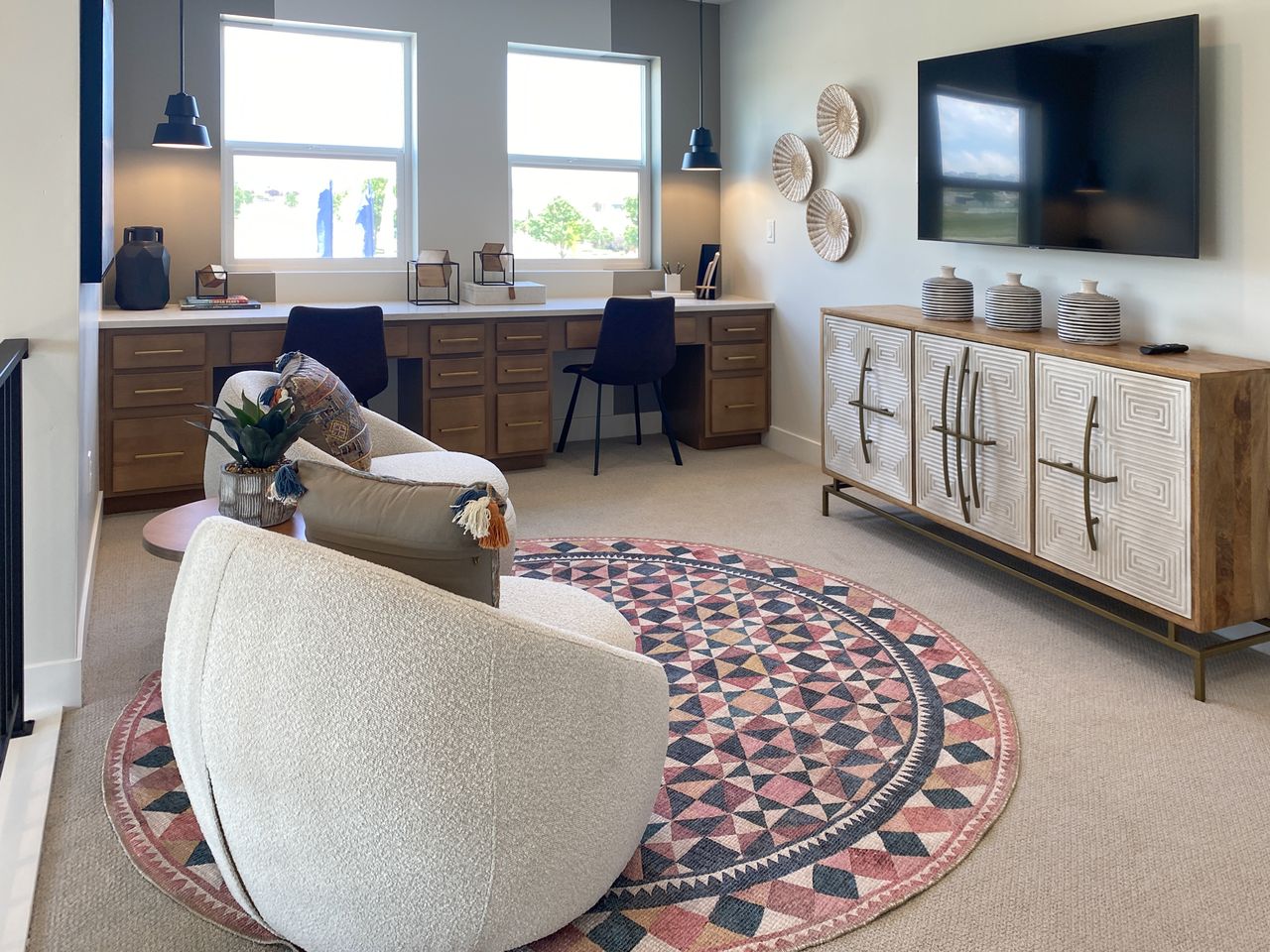 Office space featuring built in study area and light colored carpet