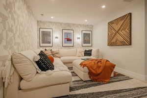 Living area featuring recessed lighting and wallpapered walls