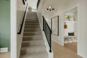 Staircase featuring wood finished floors and baseboards