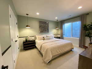 Bedroom with recessed lighting and light carpet