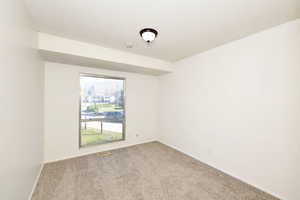 Unfurnished room featuring carpet and a textured ceiling
