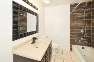Bathroom with vanity,  shower combination, and light tile patterned floors