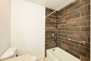 Full bathroom with toilet and  shower combination