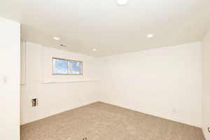 Unfurnished room featuring carpet flooring and recessed lighting