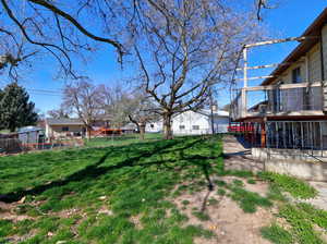 Fenced yard with a residential view and a balcony