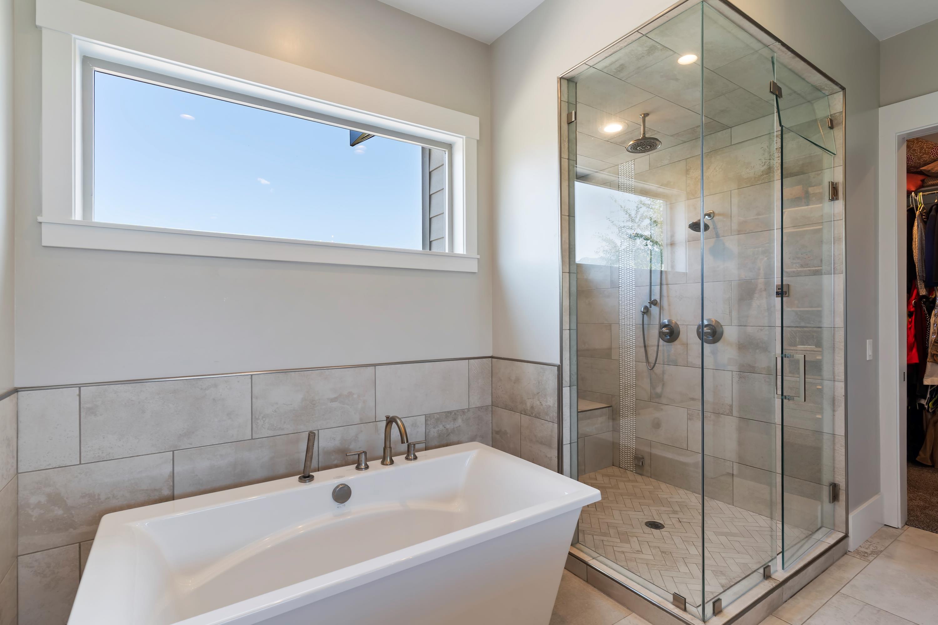 Bathroom featuring a walk in closet, a freestanding bath, a stall STEAM shower, and recessed lighting