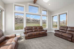 Carpeted living area featuring a mountain view, healthy amount of natural light, and recessed lighting