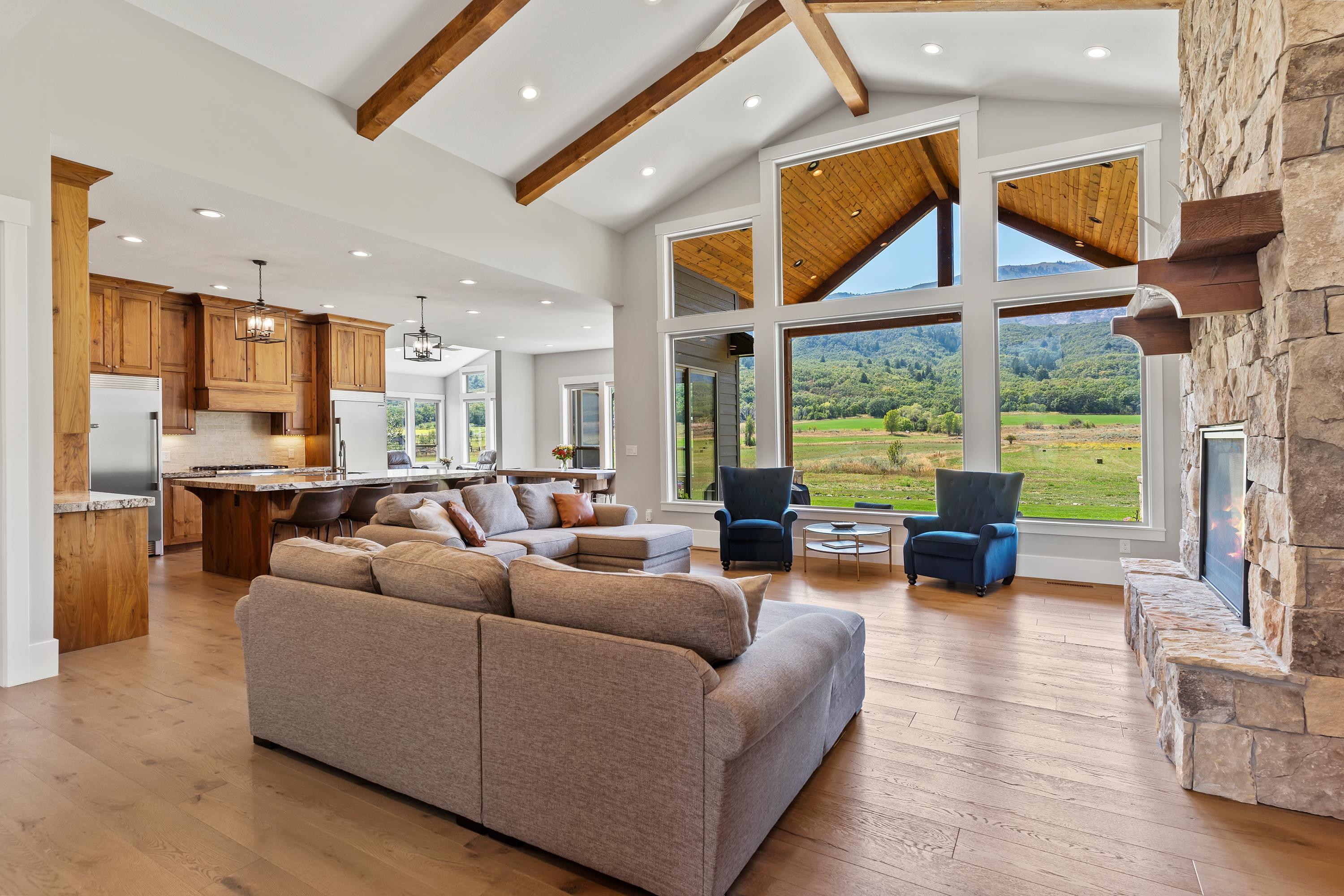 Kitchen with gas range, custom walnut wood cabinets, granite and large island. Amazing mountain views.