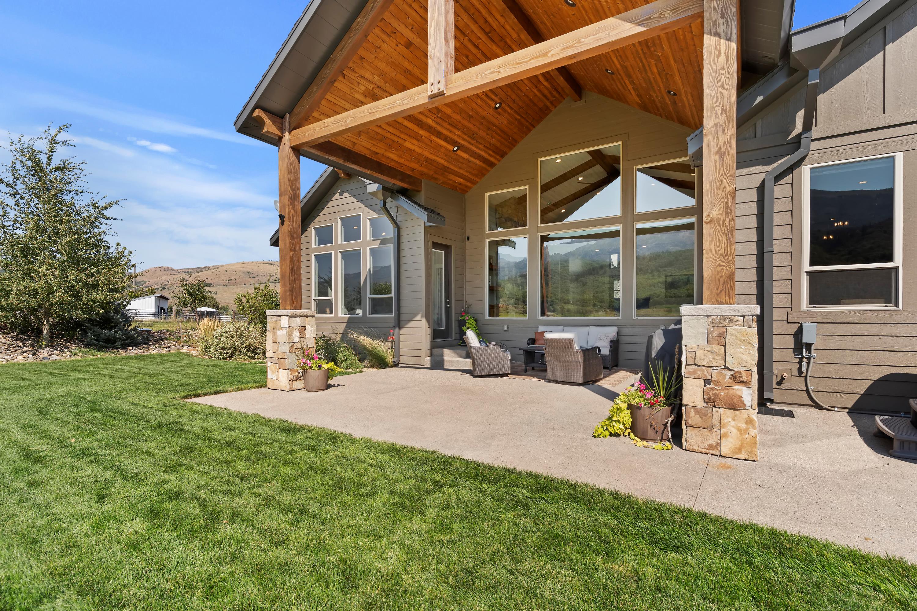 Covered porch with custom timber beams. Watching the sunsets and summers under the shade.