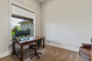 Carpeted home office near the entrance.