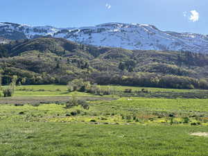 View of mountain backdrop featuring rural landscape