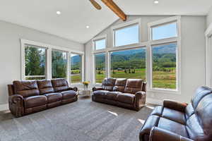 TV Family room area with a ceiling fan, carpet flooring, plenty of natural light with views, and recessed lighting
