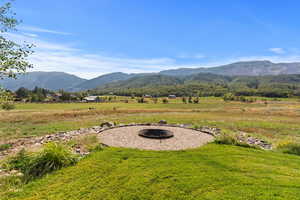 View of mountain background featuring fire pit.