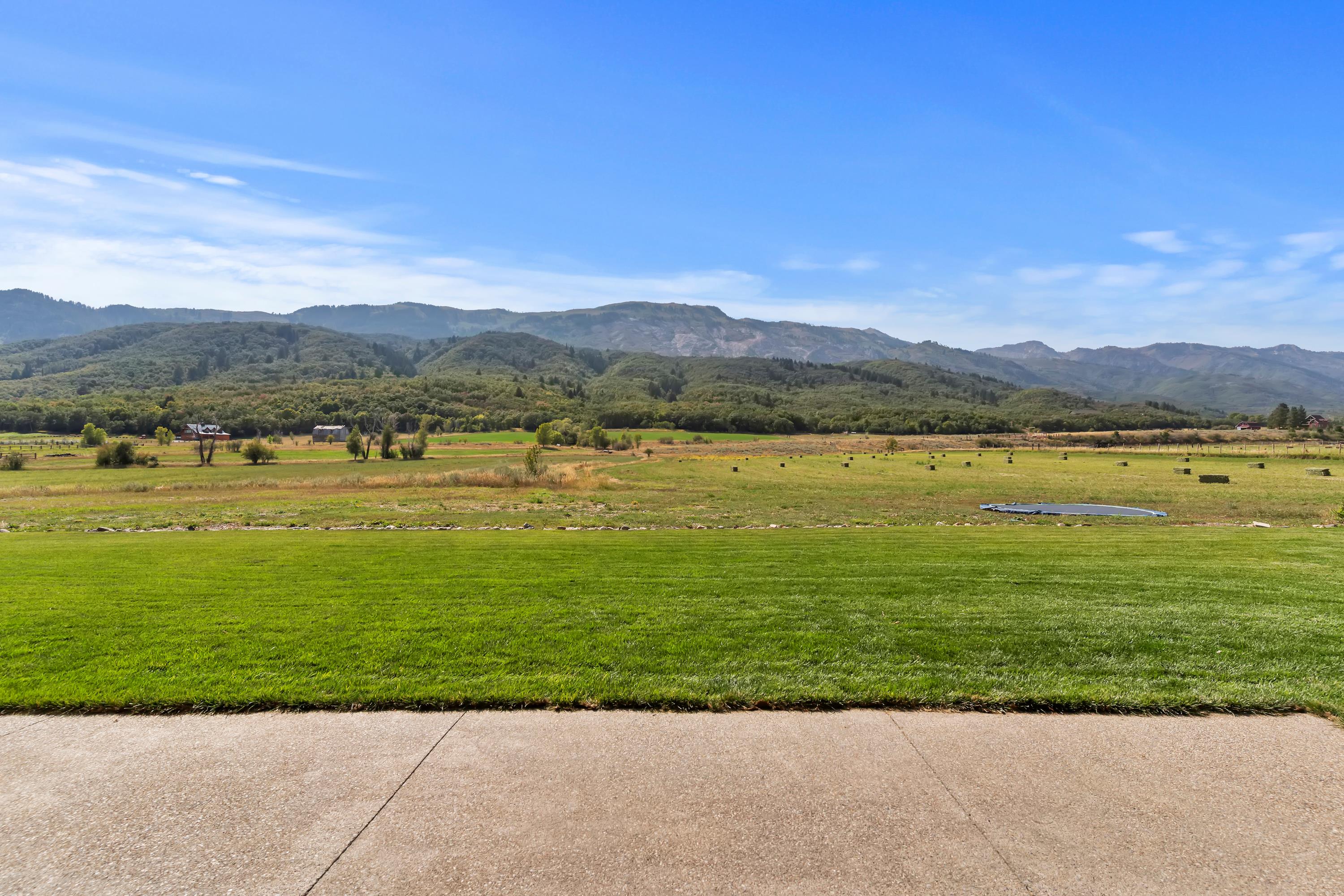 View of mountain backdrop featuring rural landscape