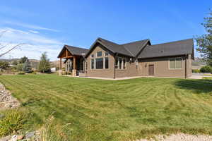 Rear view of property with a yard, a patio, roof with Presidential shingles, and a Mountain View’s