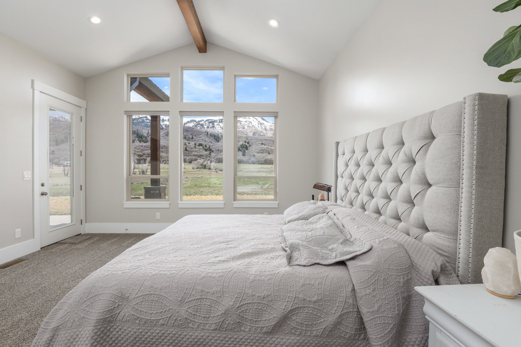 Bedroom with light carpet, beam ceiling, access to outside, a mountain view, and recessed lighting