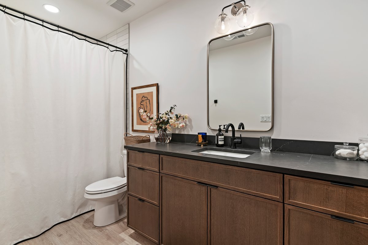 Full bathroom with vanity, a shower with shower curtain, and light wood-type flooring