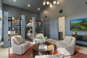Living area featuring carpet, lofted ceiling, and recessed lighting