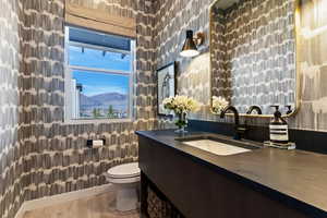 Bathroom with vanity, light wood-style floors, and a mountain view