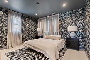 Bedroom featuring wallpapered walls, carpet flooring, and recessed lighting