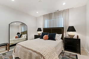 Carpeted bedroom with recessed lighting