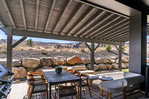 View of patio with a grill, outdoor dining space, and a mountain view