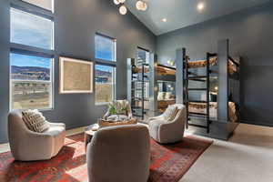Living area featuring carpet flooring, lofted ceiling, recessed lighting, and a mountain view