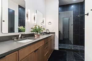Bathroom with double vanity and a shower stall