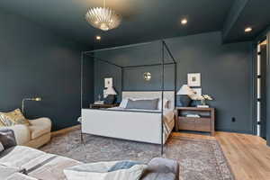 Bedroom with wood finished floors and recessed lighting